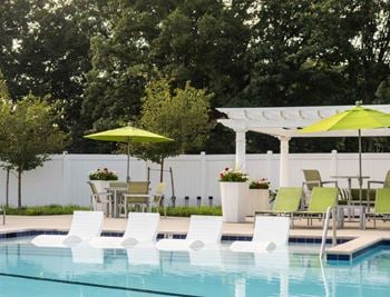 Beach entry swimming pool with sun shelf and splash pad